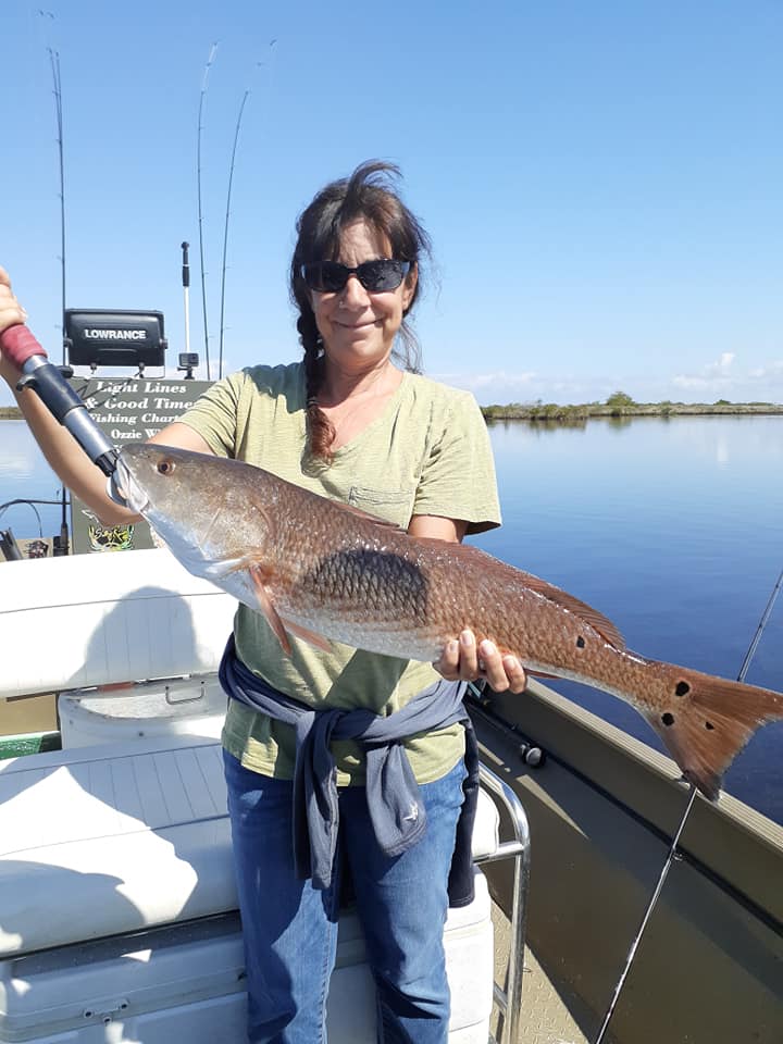 Woman holding large multi spot redfish