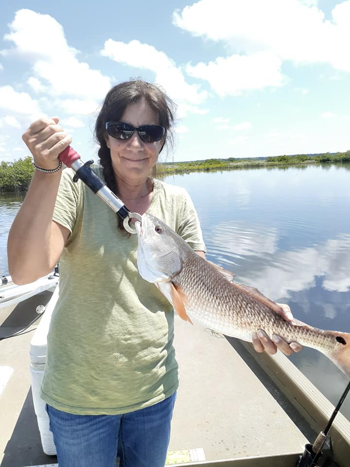 Woman holding large red fish