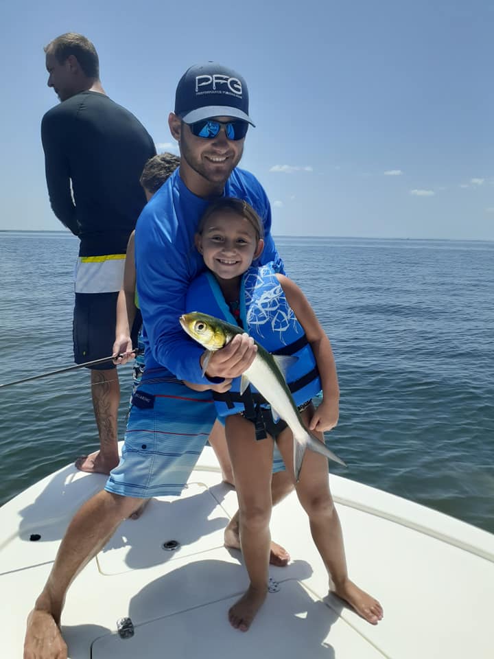 Father and Daughter holding large ladyfish